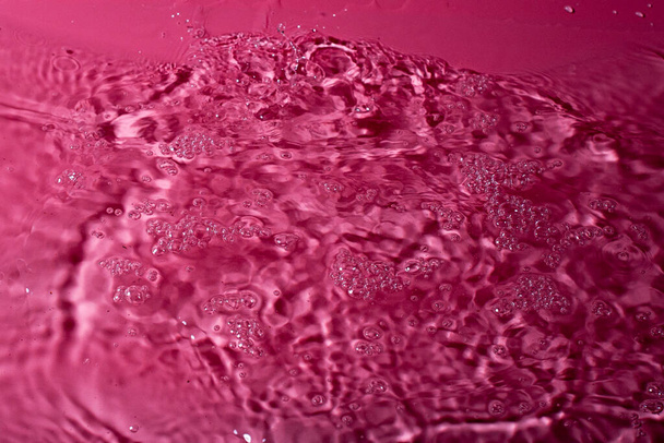splash of water on a red background. Abstract wallpaper - Фото, зображення
