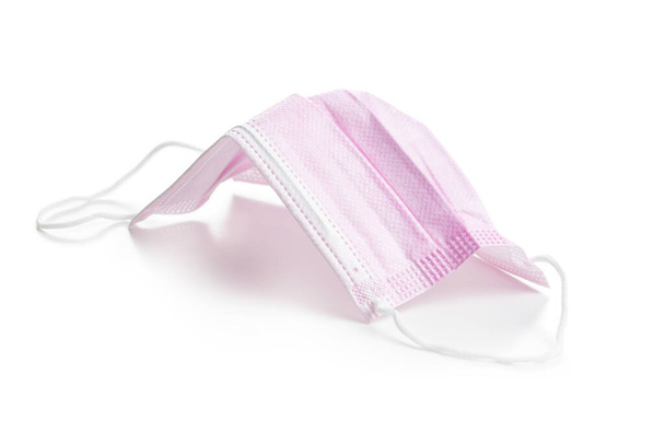 Corona virus protection. Pink medical paper face mask  isolated on white background. - Φωτογραφία, εικόνα