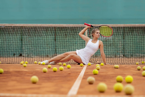 professional tennis player woman with racket and ball near net on court - Zdjęcie, obraz