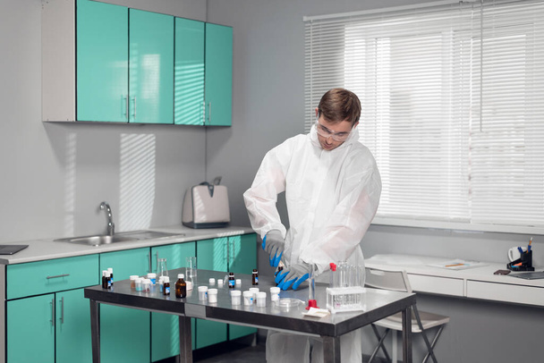 Student in the lab. Young male chemist working in the laboratory - Photo, Image