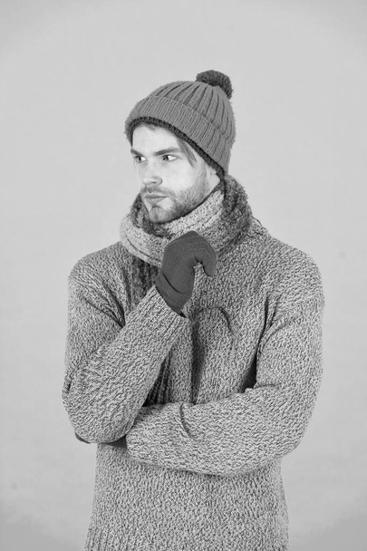 Casually handsome. Man handsome unshaven guy wear winter accessories on blue background. Winter season sale. Hipster knitted winter hat scarf and gloves. Shopping concept. Emotional expression - Foto, Bild
