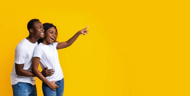 African-american man and woman pointing at empty space - Photo, Image