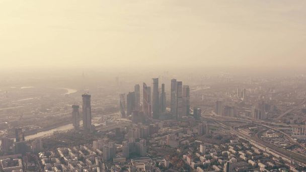 Aerial shot of Moscow involving skyscrapers of the financial district and the western part of the city on a hazy day. Russia - 写真・画像