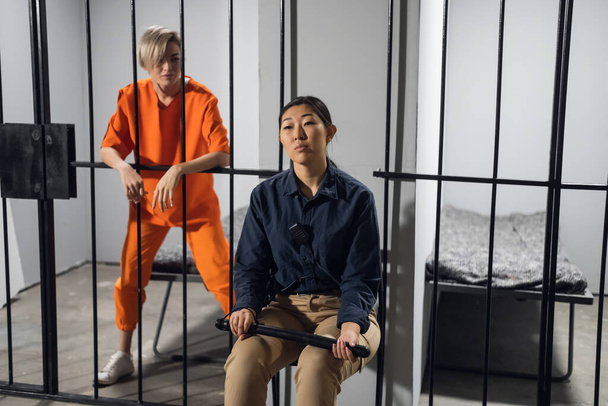 A normal day in a womens prison, a female warden is on guard for a female criminal - 写真・画像