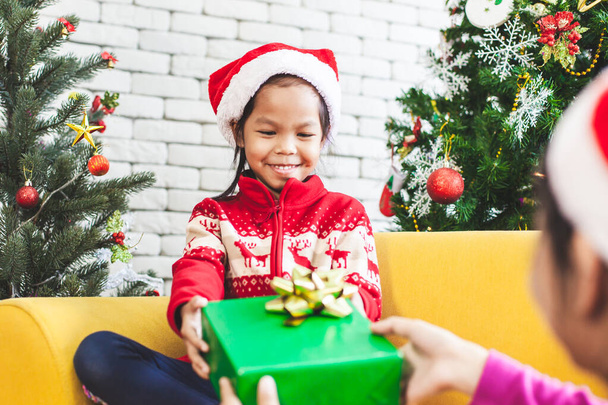 Rodič dávat vánoční dárek box na roztomilé asijské dítě dívka na vánoční oslavu - Fotografie, Obrázek