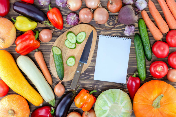 Notebook And Fresh Vegetables Background On Wooden Table. Raw Food Concept. - Fotografie, Obrázek