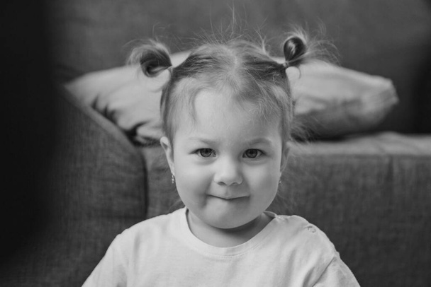 portrait of a naughty little girl with two ponytails. concept of childhood, health care, IVF - Photo, image