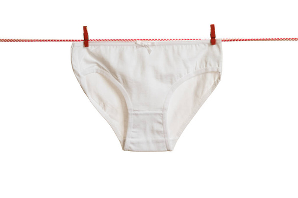 Classic women's white panties on a red clothesline isolated on a white background. - Photo, Image
