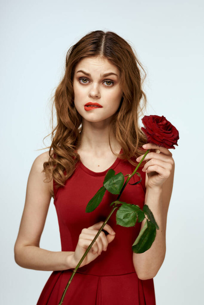 Pretty woman with rose in her hands charm gift lifestyle studio light background - Foto, Imagem