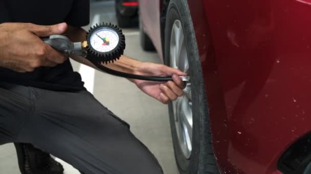 Slow footage of inspection Measure quantity Inflated Rubber tires car Close up hand holding machine Inflated pressure gauge for car tire pressure measurement for automotive automobile - Footage, Video
