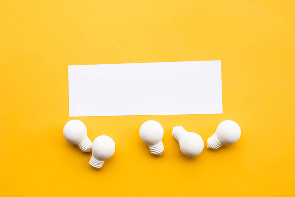 Business creativity and inspiration concepts with lightbulb and blank white paper on yellow background. motivation for success.think big ideas - Photo, Image