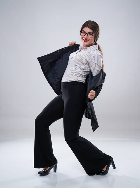 Cheerful businesswoman dancing with joy in formal suit - Foto, Imagen