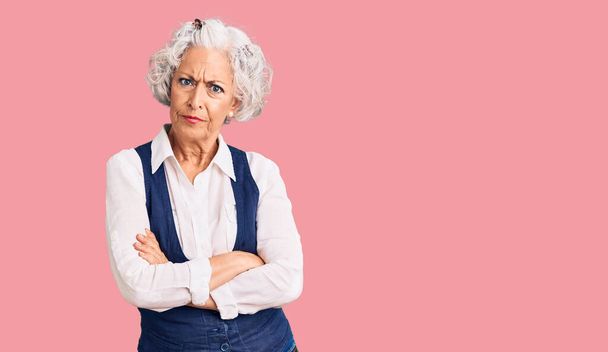 Senior grey-haired woman wearing casual clothes skeptic and nervous, disapproving expression on face with crossed arms. negative person.  - Photo, Image