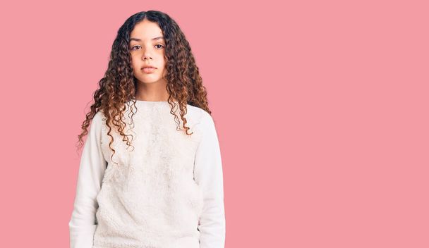Beautiful kid girl with curly hair wearing casual clothes relaxed with serious expression on face. simple and natural looking at the camera.  - 写真・画像