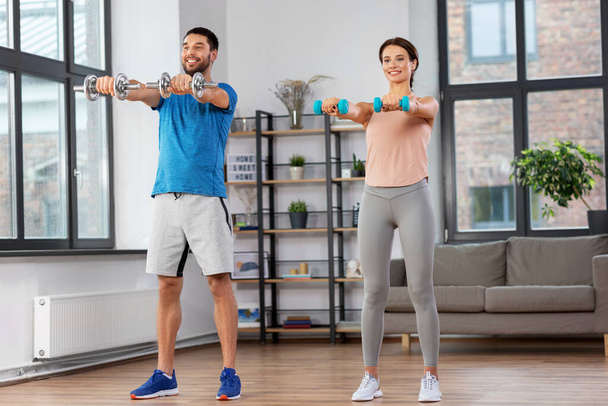 happy couple exercising at home - Photo, Image