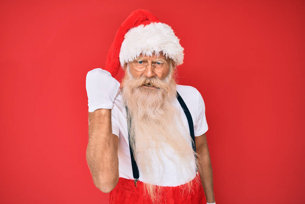 Gri saçlı, uzun sakallı, beyaz tişörtlü, Noel Baba kostümlü kızgın, sinirli sinirli ve öfkeyle bağıran yaşlı bir ihtiyar. öfke ve agresif konsept.  - Fotoğraf, Görsel