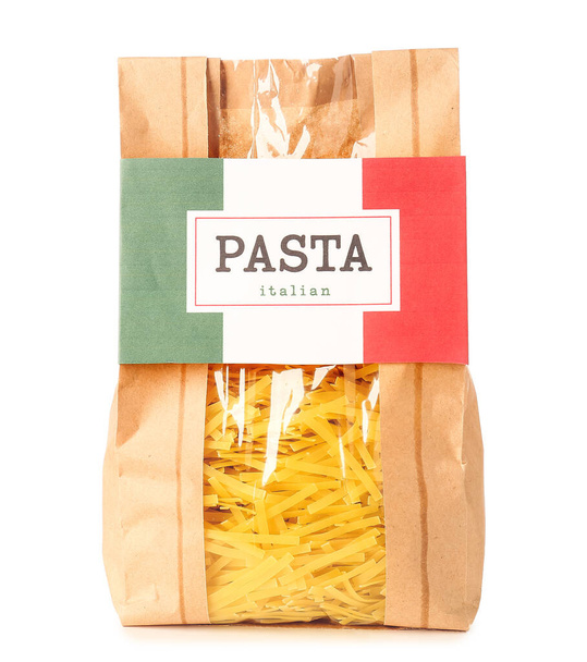 Bag with uncooked Italian pasta on white background - Φωτογραφία, εικόνα