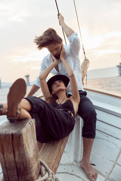 a romantic trip by sea on the yacht of a stylish couple in love, who emotionally show their feeling - Photo, Image