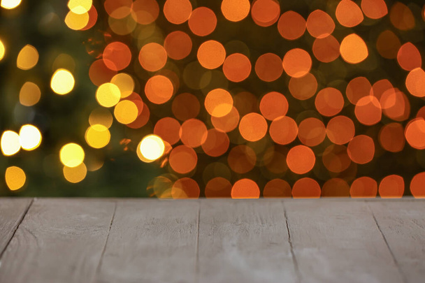 View of table against blurred Christmas lights - Photo, Image