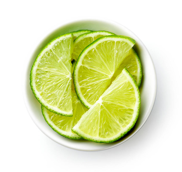 White bowl of lime half slices isolated on white background, top view - Photo, Image