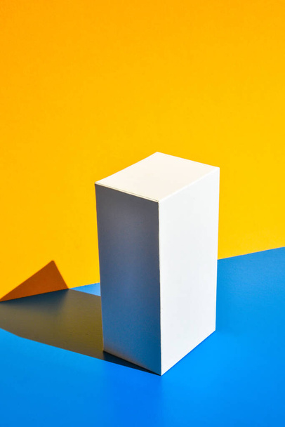 White box. Drugs box mock-up. Mockup. Copy space. Yellow and blue creative minimalism isometric background. Hard light. Shadows - Photo, Image