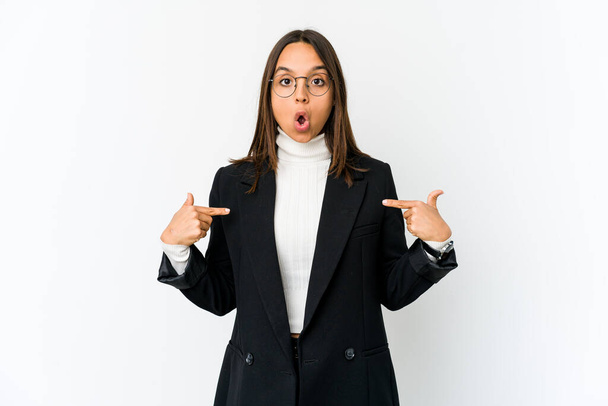 Young mixed race business woman isolated on white background points down with fingers, positive feeling. - Фото, зображення