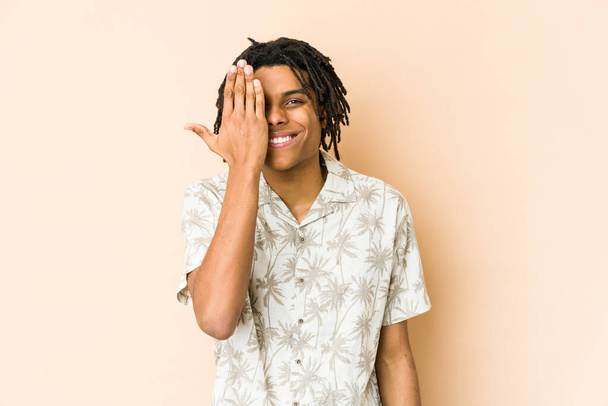 Young african american rasta man having fun covering half of face with palm. - Foto, immagini