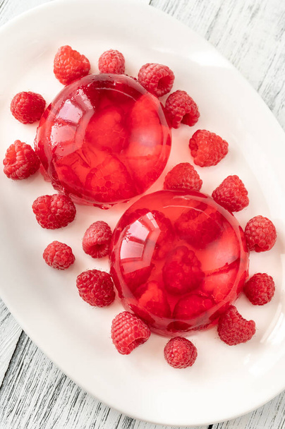 Portion of raspberry gelatin dessert on white plate - Foto, Bild