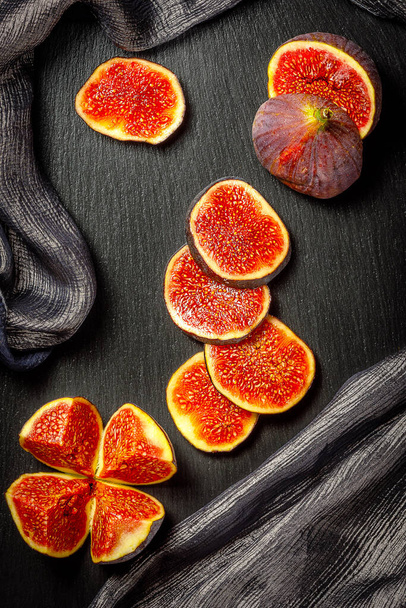 still life with slices of figs on stone board, top view - Photo, Image