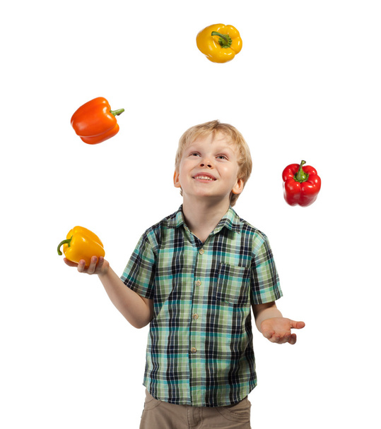 Little boy juggles some fruits and vegetables - Zdjęcie, obraz