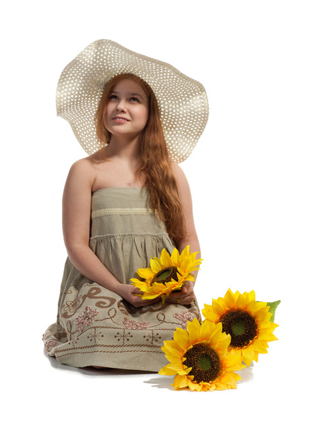 Little girl with summer hat and sunflowers - Фото, изображение