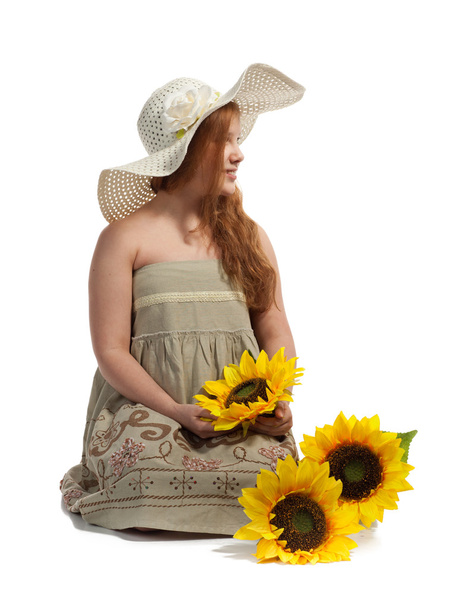 Little girl with summer hat and sunflowers - Fotoğraf, Görsel