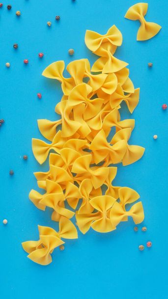 Farfalle pasta on a blue background - Photo, Image