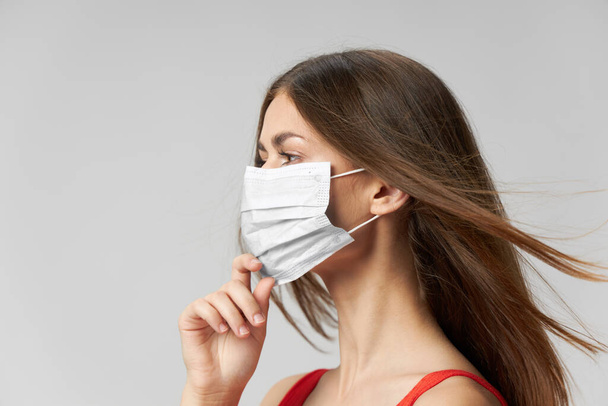 Woman medical mask on face side view light background  - Photo, Image