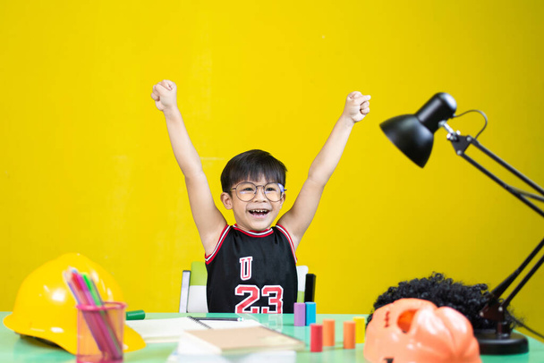 Happy boy wearing glasses, There are things for learning on the table. - Фото, зображення