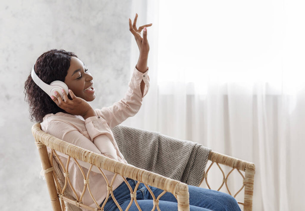 Favorite Leisure. Joyful Black Female In Wireless Headphones Listening Music And Singing - Fotografie, Obrázek