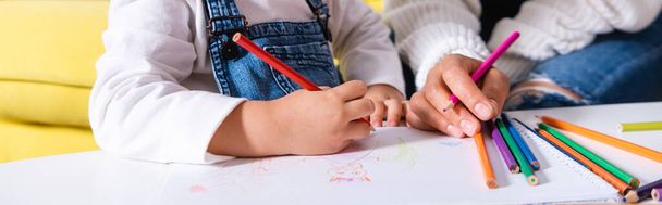 Panoramic shot of daughter and mother drawing with color pencils - Фото, изображение