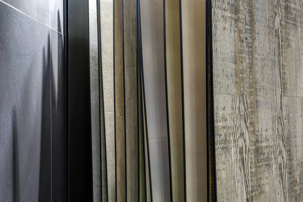 rows of ceramic tiles and natural stone inside of interior modern showroom shop - Foto, afbeelding