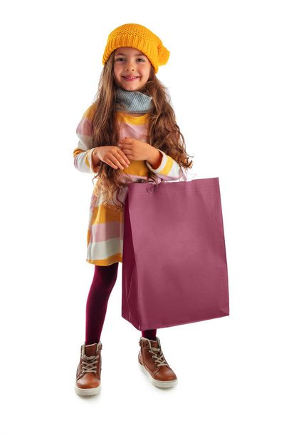 Happy beautiful young girl with shopping bag, portrait on white background - Photo, image