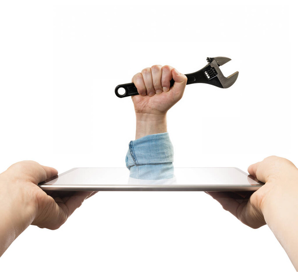 The human hand with  black wrench stick out of a digital tablet screen. Concept of technical support. Isolated on white. - Foto, immagini