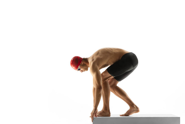Caucasian professional sportsman, swimmer training isolated on white studio background - Fotó, kép