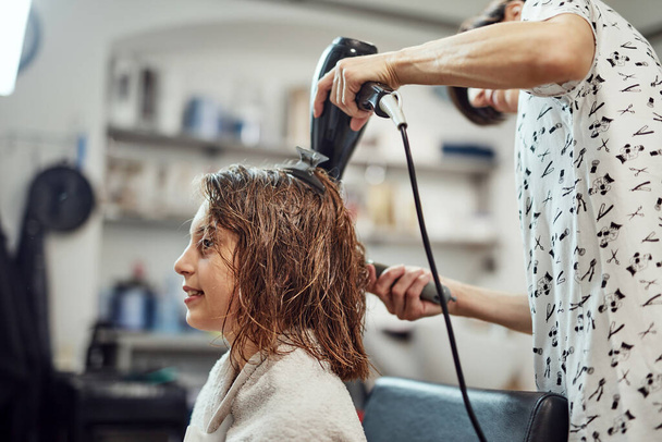 Hairdresser cutting hair in a salon. - Photo, Image