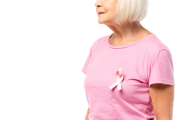 Cropped view of pink ribbon of breast cancer awareness on t-shirt on senior woman isolated on white - Zdjęcie, obraz