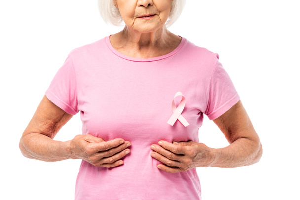 Cropped view of grey haired woman with pink ribbon on t-shirt touching breast isolated on white - Zdjęcie, obraz
