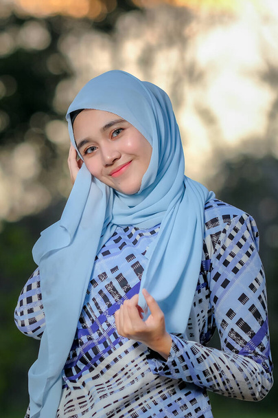 Portrait of beautiful young model  in fashionable hijab style posing in beautiful sunset . Stylish Muslim female hijab fashion lifestyle portraiture concept. - Photo, Image