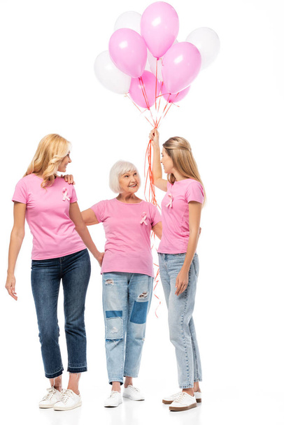 Women with balloons ad ribbons of breast cancer awareness embracing on white background - Fotografie, Obrázek