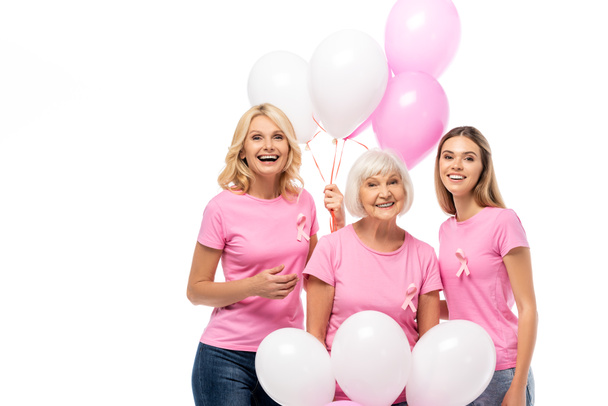 Frauen mit Brustkrebsbändern halten Luftballons auf weißem Grund - Foto, Bild