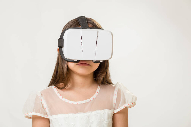 Young girl wearing virtual reality VR goggles - Фото, зображення