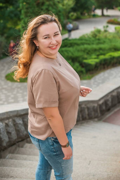 Happy smiling beautiful plus size model . Portrait large girl smiling on a sunny day with good mood, Photo of new age standard of beauty - Photo, Image