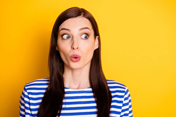 Portrait of astonished girl hear gossip stare stupor copyspace wear striped clothes isolated over vivid color background - Foto, Imagen